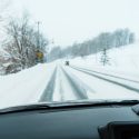 View of a snowy road from a car