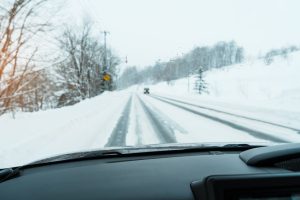 View of a snowy road from a car